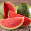 two-crimson-sweet-watermelon-on-a-chopping-board-one cut-into-slices