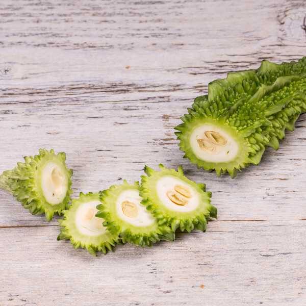 bitter-melon-styled-seeds bitter melon fruit cut in a cross sectional style to show the inside of the fruit