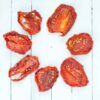 sundried Principe Borghese tomatoes on a white wood board