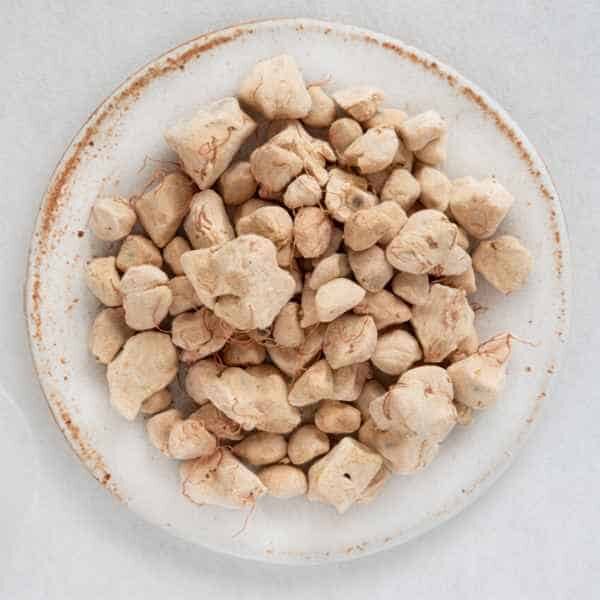 baobab-tree-seeds-2 white plate on white paper filled with baob seeds